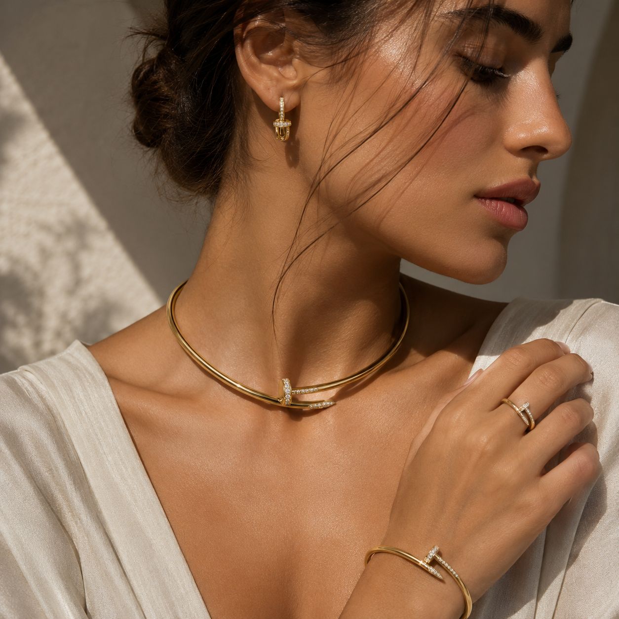 Gold collar necklace worn in soft light